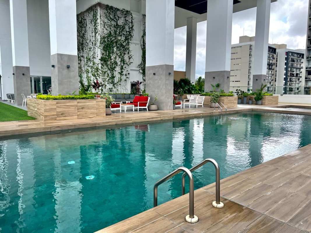 Rooftop pool deck with lounge seating and vertical garden in Greenwood Towers Panama