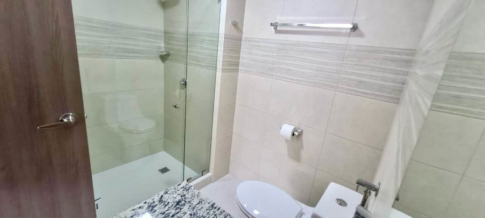 Contemporary bathroom with glass shower enclosure and granite countertop PH Greenwood Towers Condado del Rey Panama