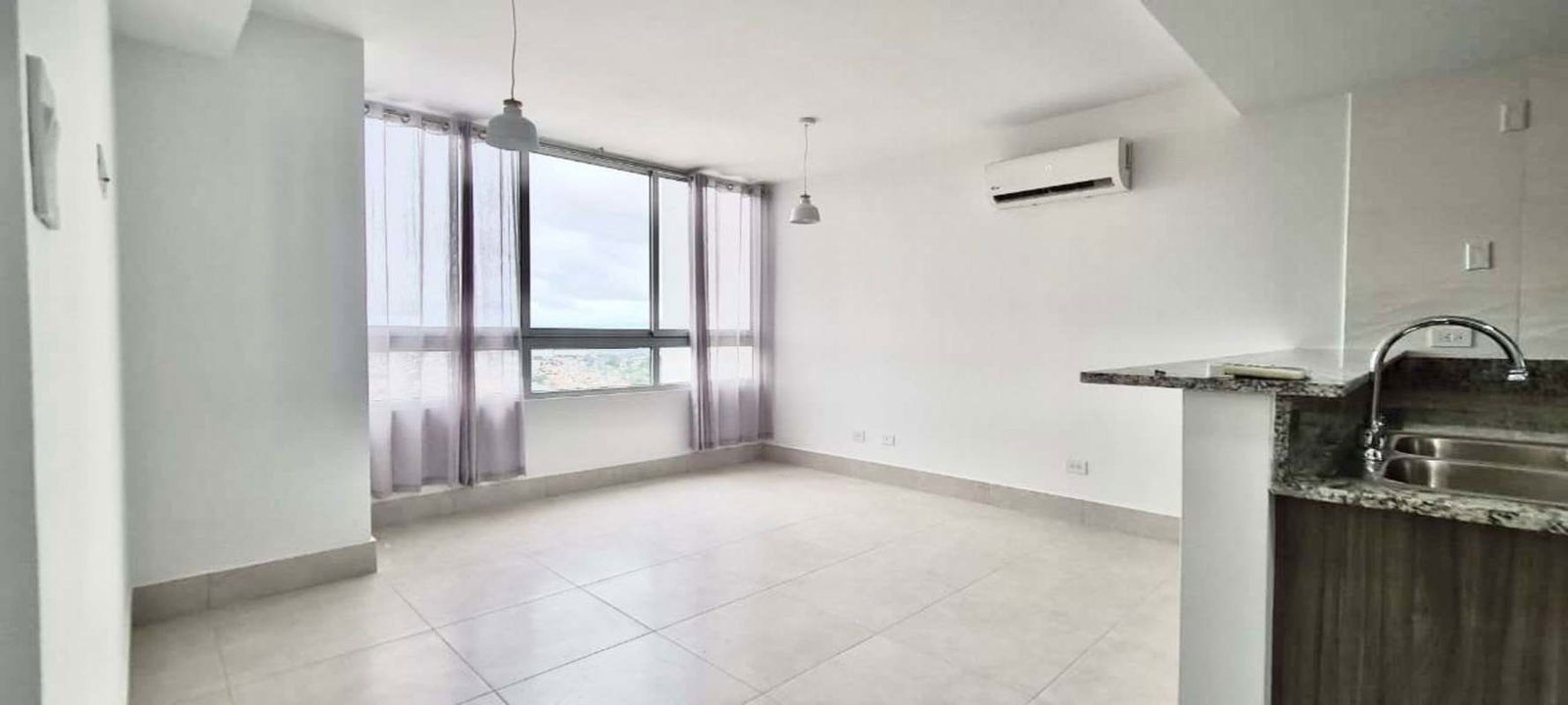 Living room with natural light and open kitchen design PH Greenwood Towers Condado del Rey Panama