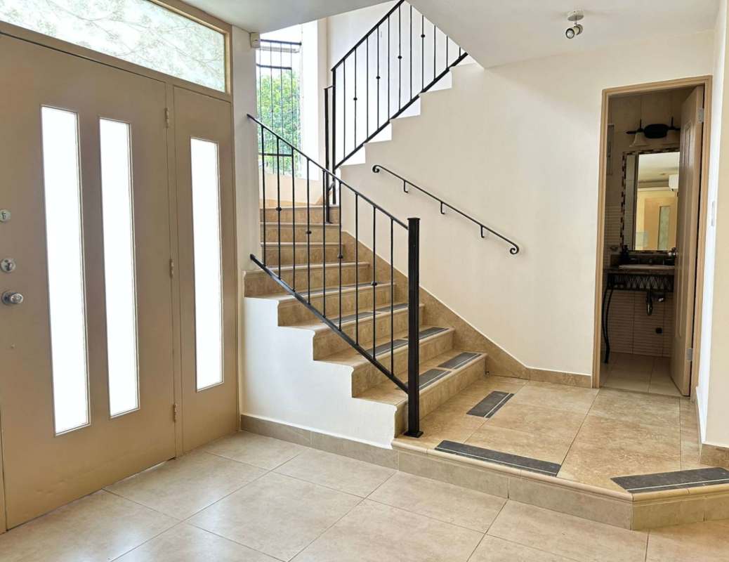Bright living room with large windows, ceiling fans, AC and garden view in Clayton house