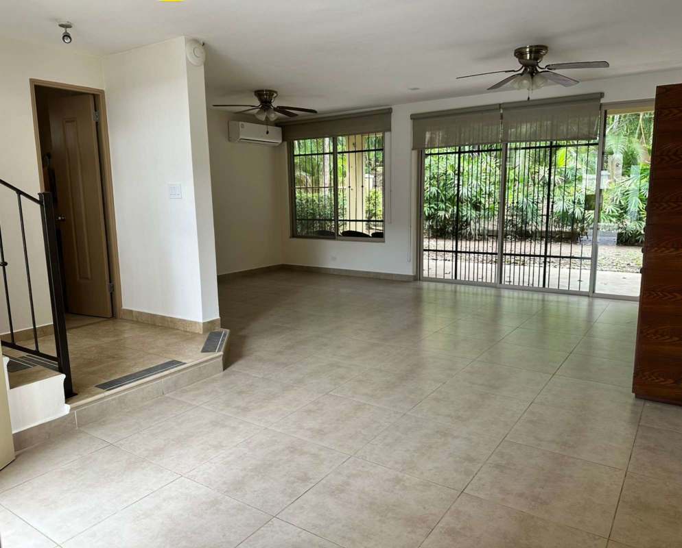 Living room with sliding doors, garden views, AC and ceiling fans in house for rent in Clayton