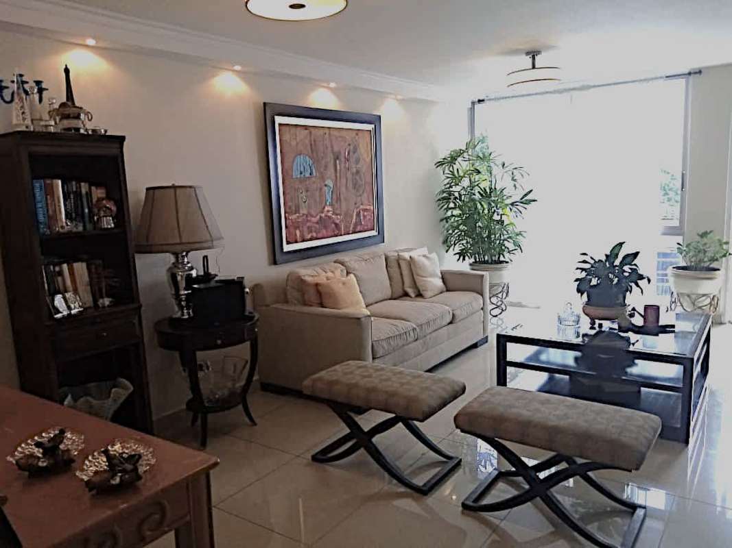 Functional kitchen with granite counters, cabinets, breakfast pass-through in El Cangrejo apartment