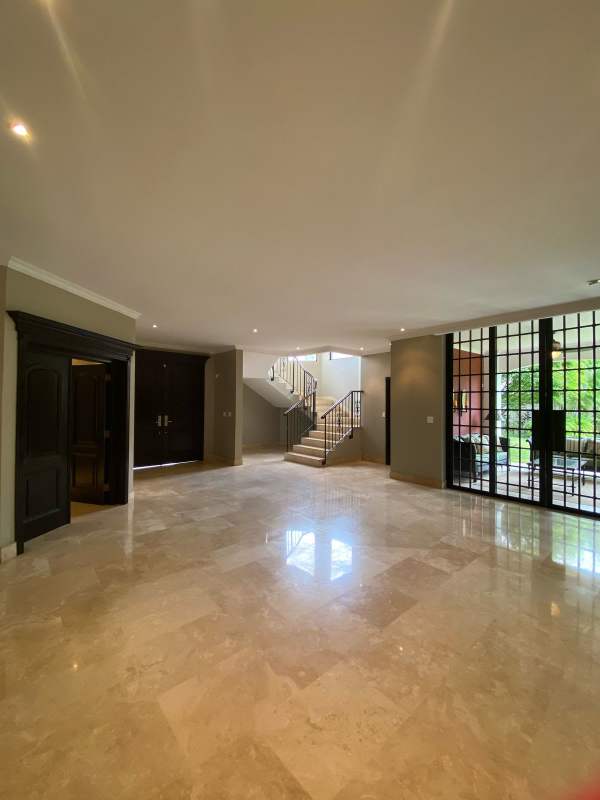 Spacious kitchen with granite countertops, island and wood cabinetry in Costa del Este