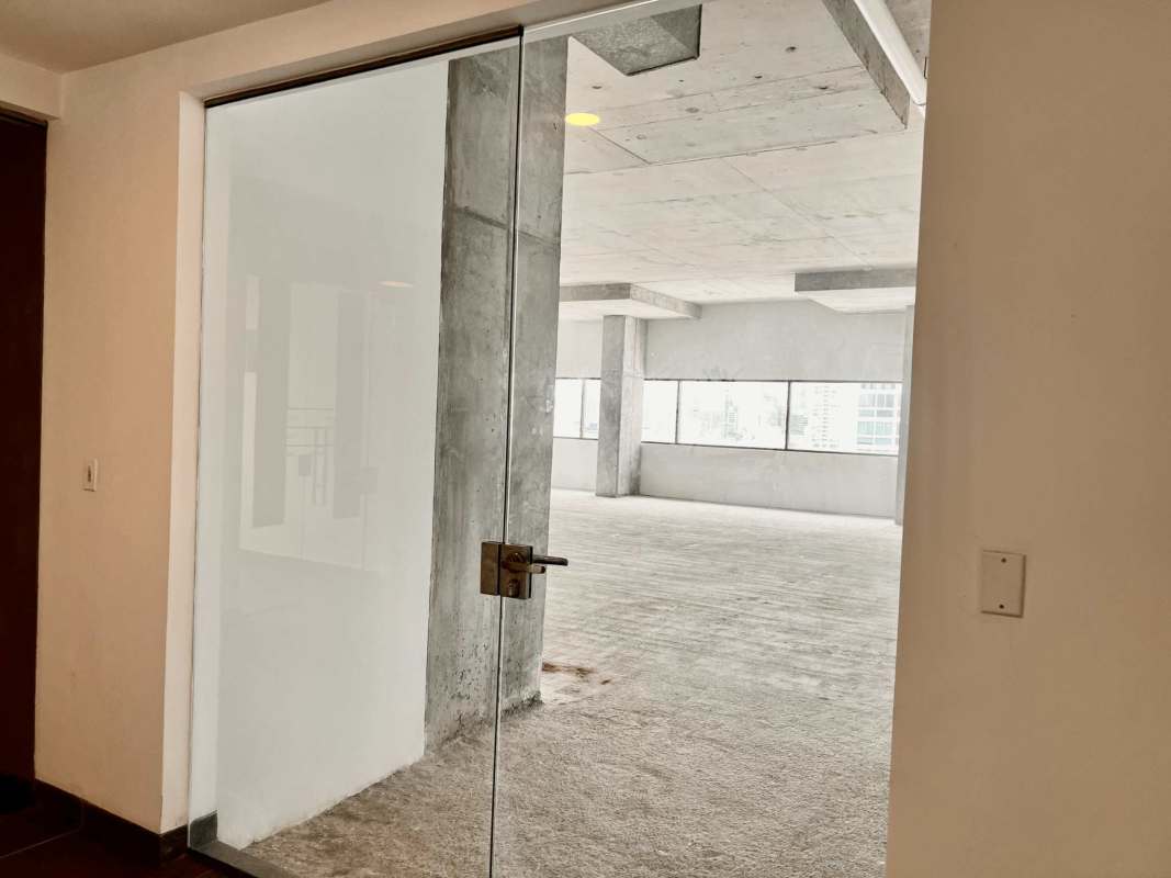 Spacious unfinished interior with floor-to-ceiling windows and columns in PH Midtown Panama City