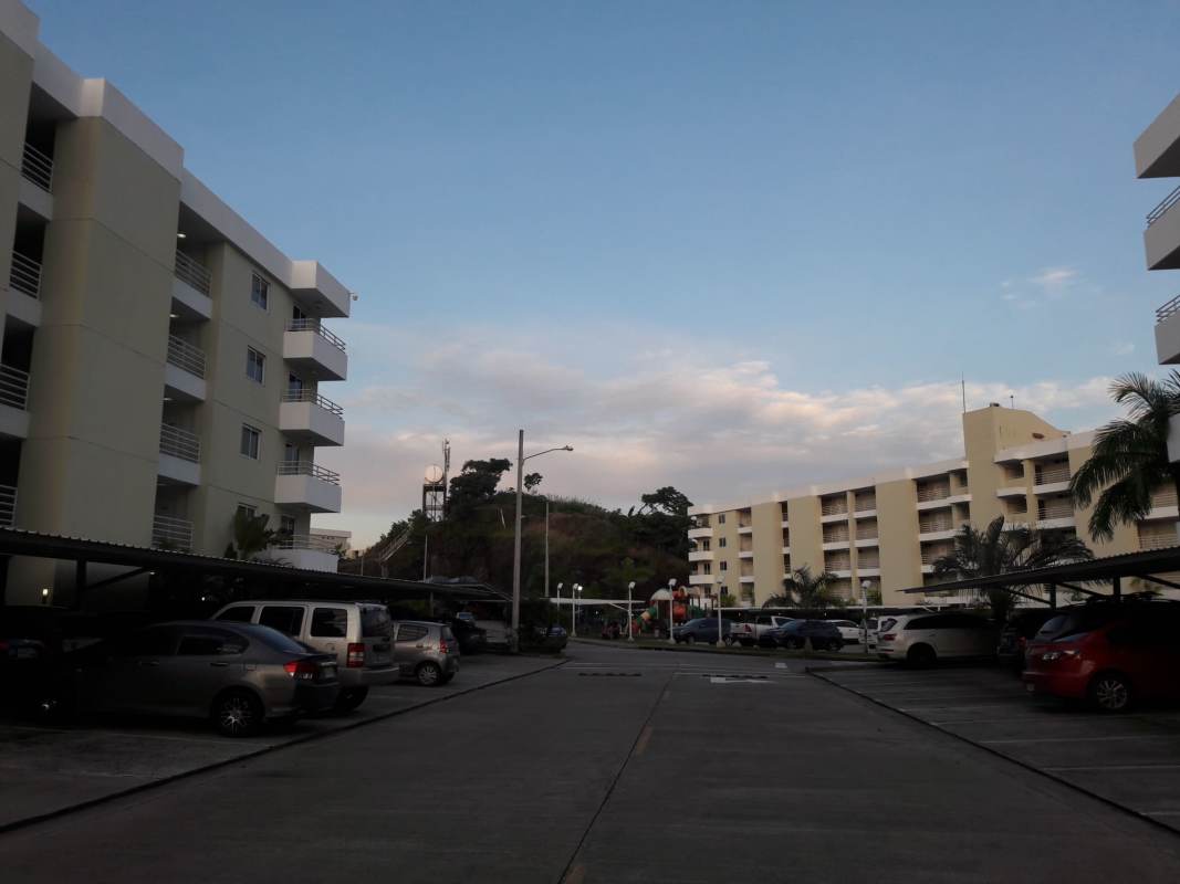 Outdoor pool with sun loungers, water features, mountain backdrop in Altamira Gardens Panama City