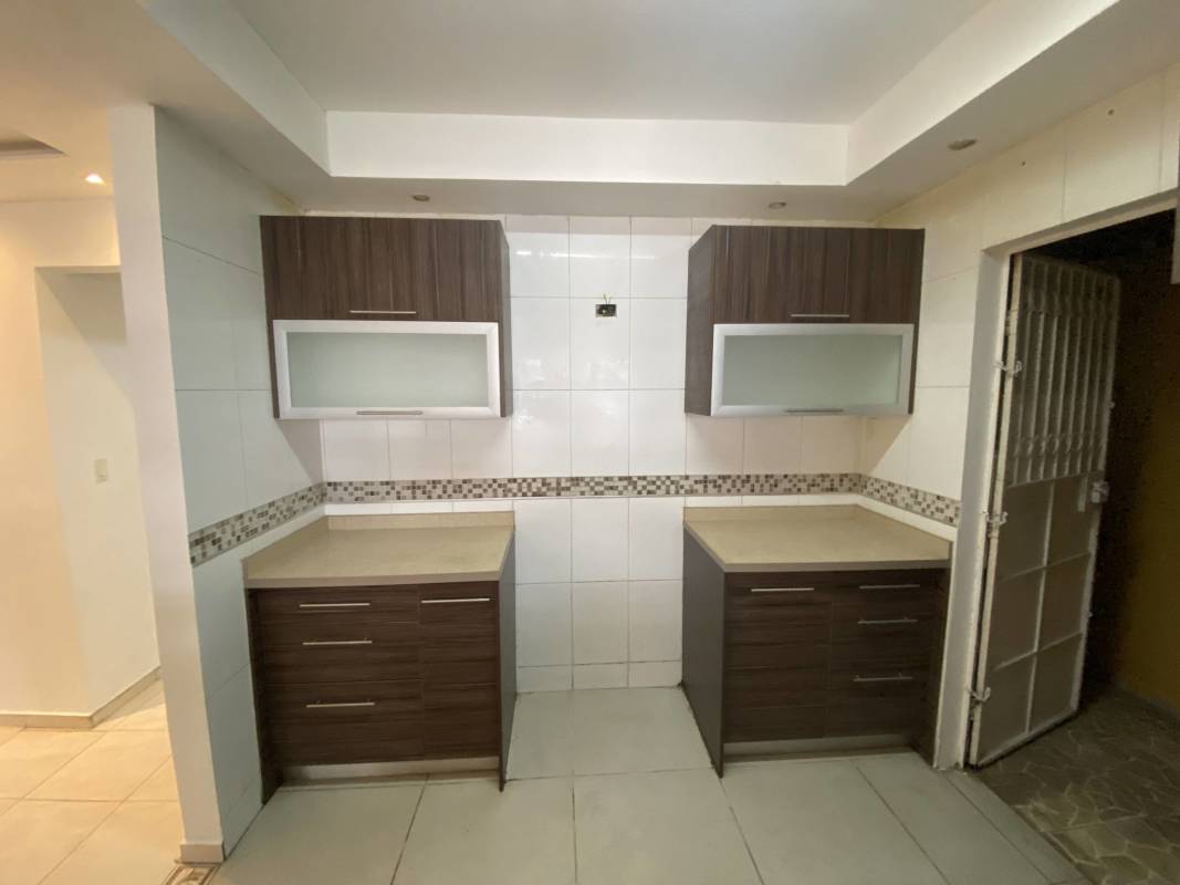 Remodeled kitchen with mosaic backsplash, glass cabinets, beige counters in San Antonio Panama City