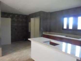 Large swimming pool with terracotta tile deck surrounded by greenery in Rio Hato Panama