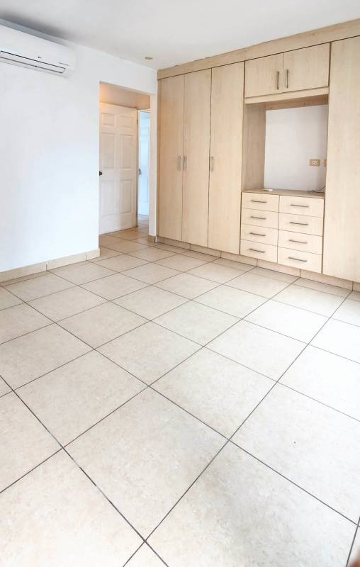 Bright bedroom with built-in closet, tile floor, city window at PH Costa View Panama