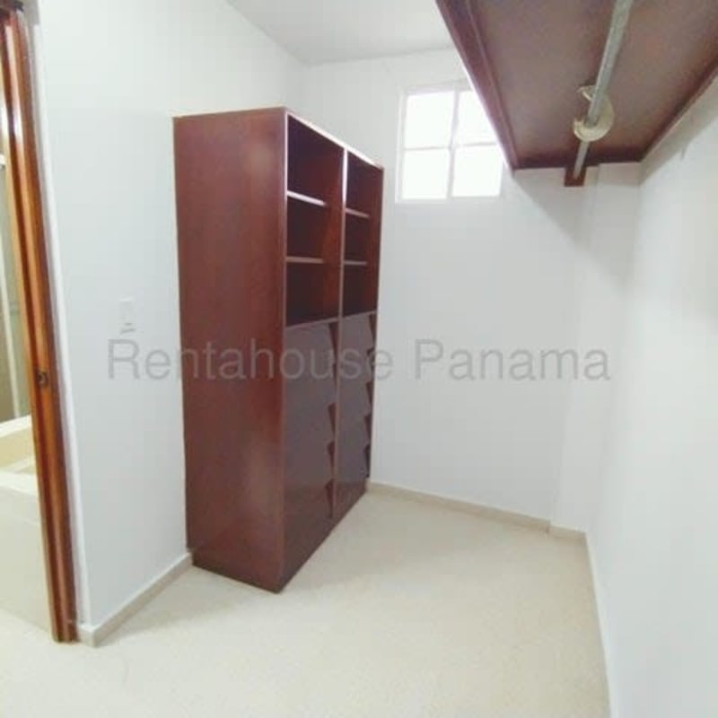 Spacious walk-in closet with built-in shelves and hanging space Costa Bella house Panama