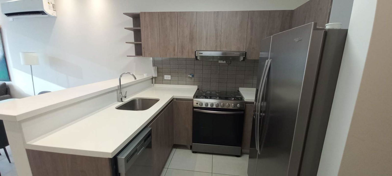 Modern kitchen with granite countertops and dishwasher in Coco del Mar apartment rental Panama