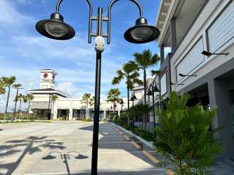 View of Costa Verde commercial plaza with ample parking and palm trees Panama