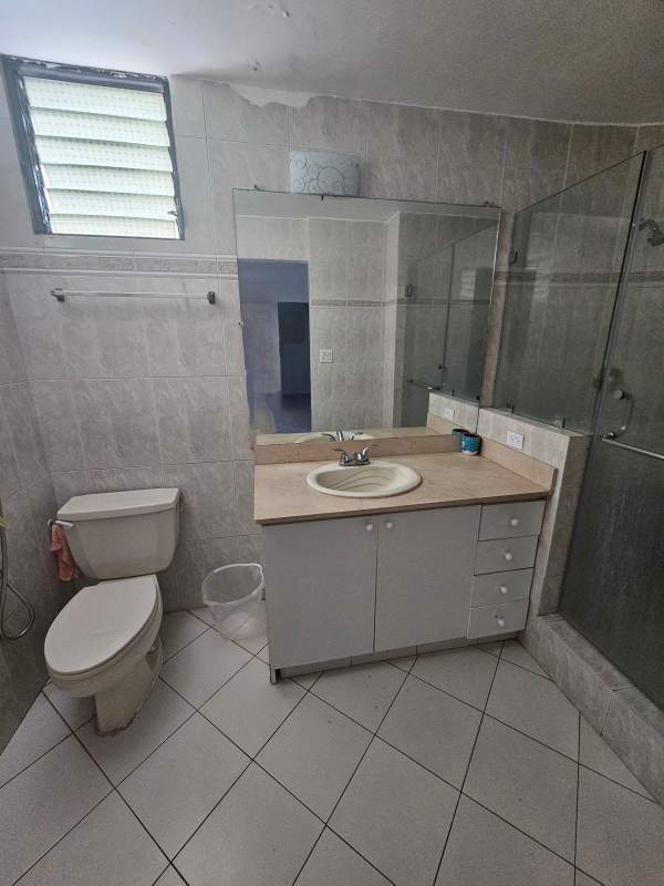 Minimalist furnished bedroom with closet, tiled floors and ceiling fan in PH Miraluz apartment at Punta Paitilla Panama