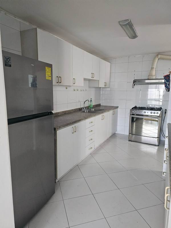 Bright furnished living room with large windows and balcony access at PH Miraluz Punta Paitilla Panama City apartment