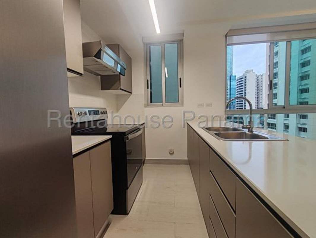 Modern kitchen with large windows and cityscape view in PH Urbana Obarrio Panama