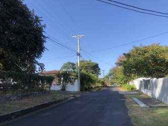 Quiet paved street and tree-lined entrance of Coronado Resort in Panama
