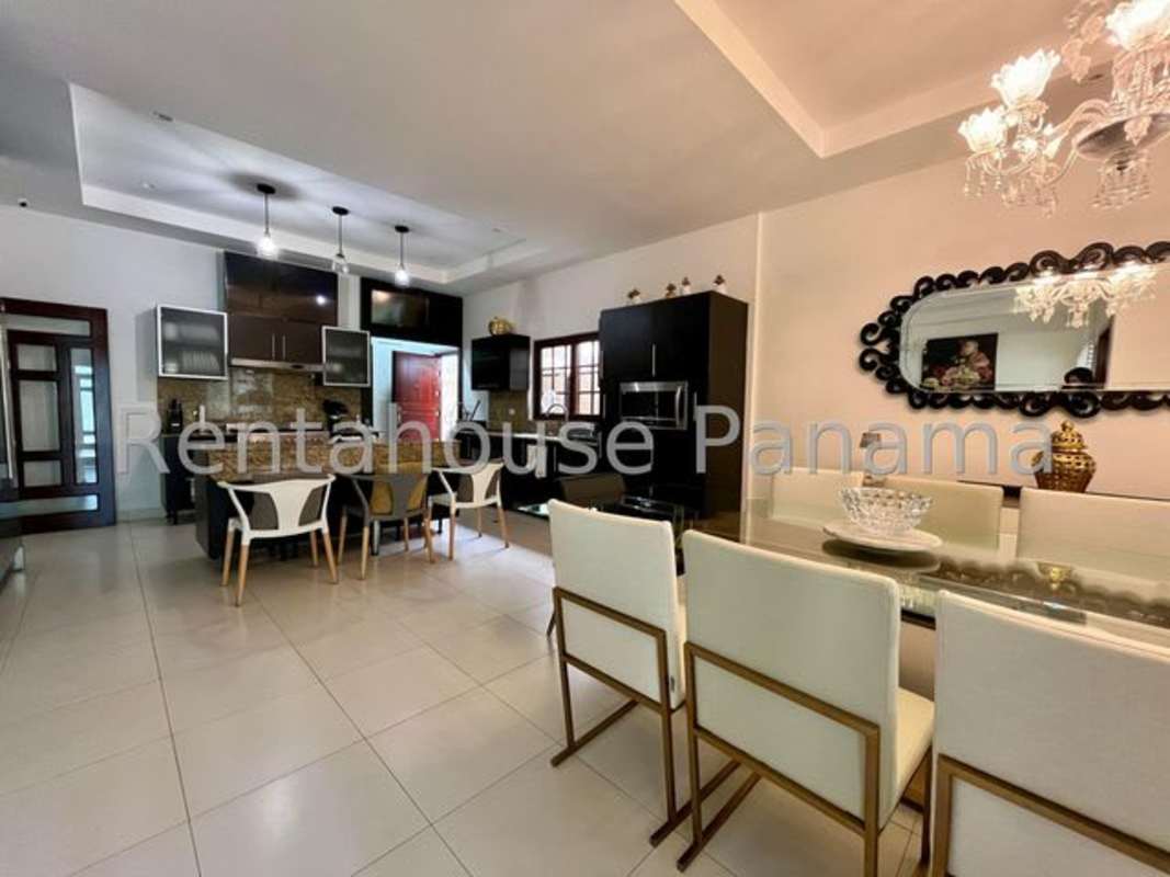 Spacious modern living room with chandelier and large windows in Sunset Coast Costa Sur Panama