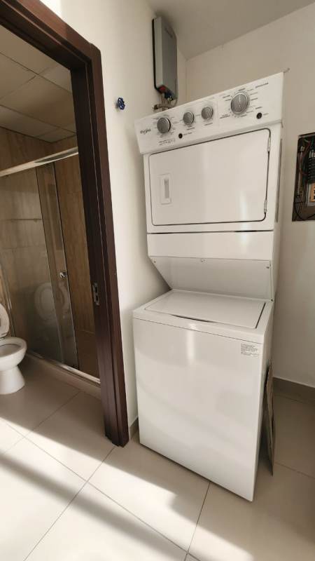 Bright open-plan living dining kitchen area with large windows Costa del Este Panama