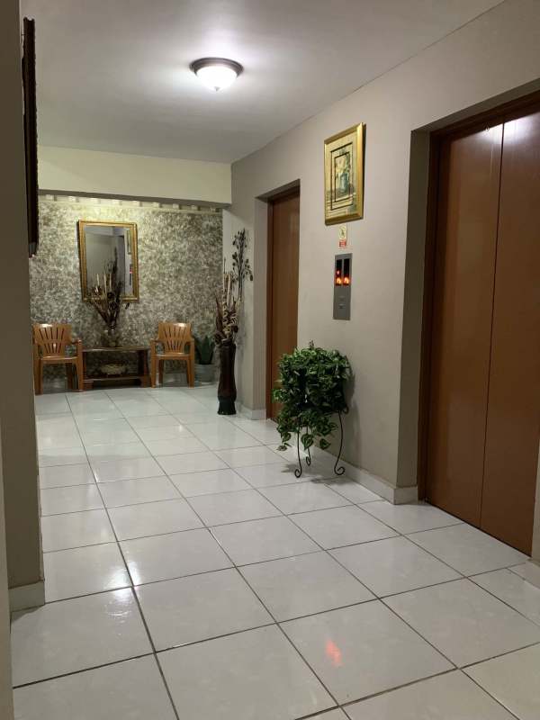 Elegant lobby with elevators, mirror, plants in PH Brisas de San Fernando Panama City