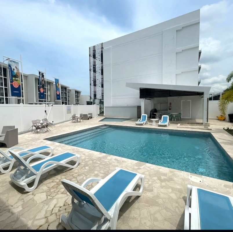 Outdoor pool with loungers and shade at Panama Viejo Residences apartment complex