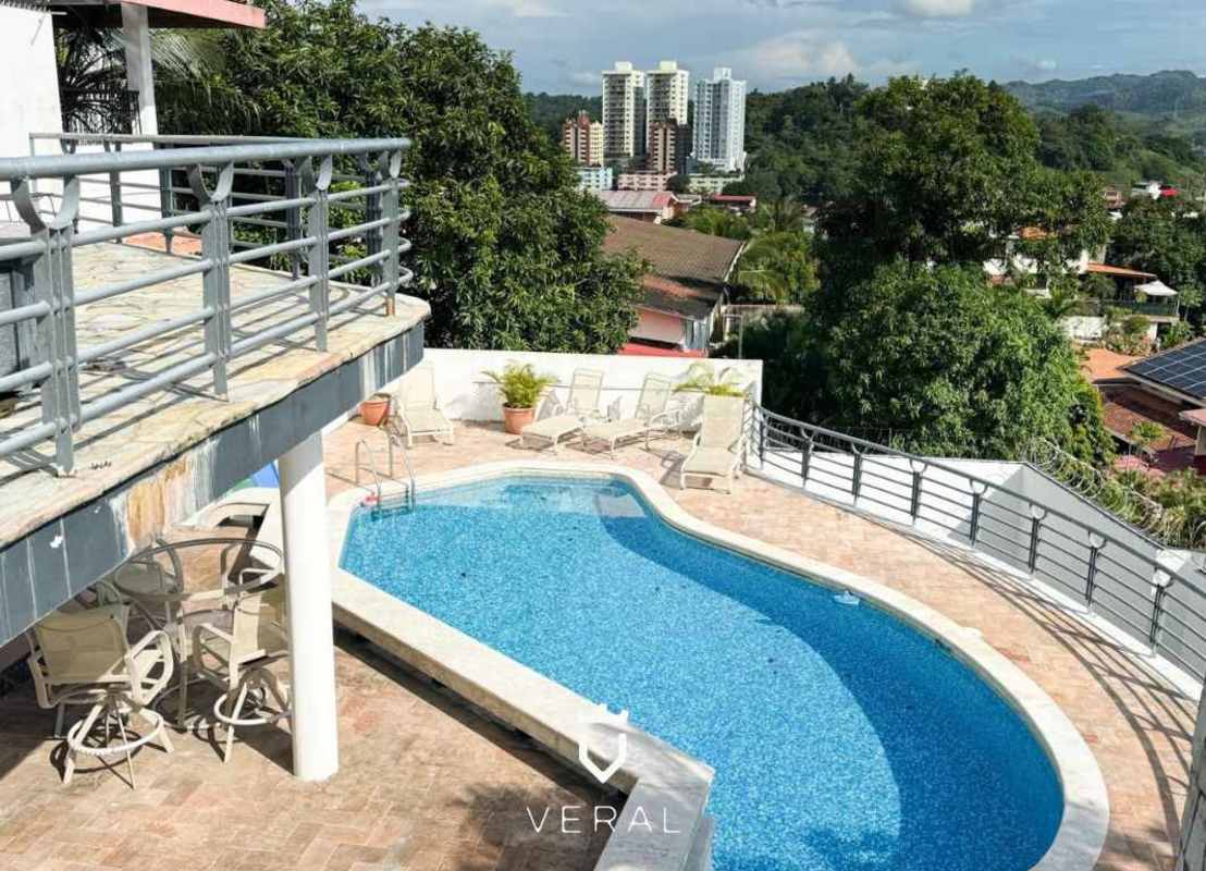 Outdoor terrace with private curved swimming pool and panoramic city views in Betania Panama