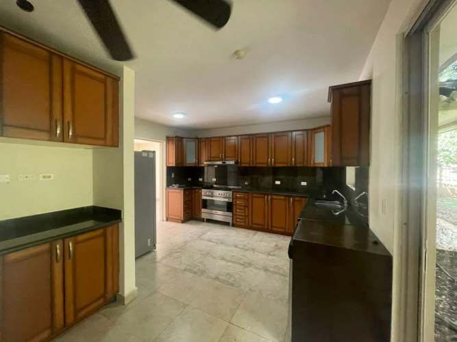 Spacious kitchen with wood cabinets, granite countertops, stainless appliances, Embassy Gardens Clayton Panama