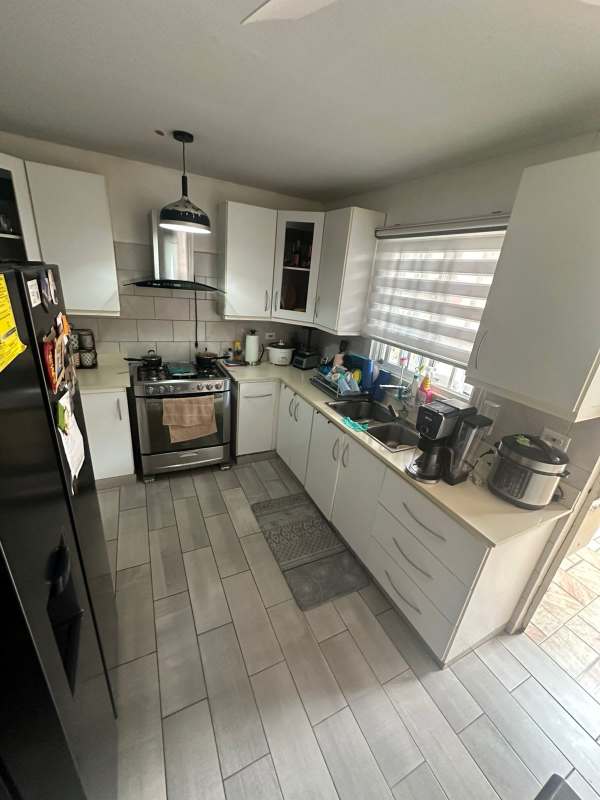 Contemporary kitchen with cabinetry, tile flooring, and stove in Villa Zaita Panama