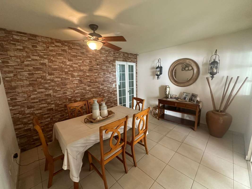 Large terrace with dining table and garden view in Villa Zaita Panama