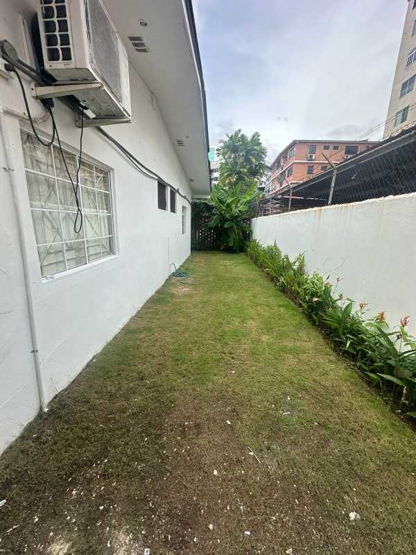 Front view of single-family house with garden lawn and secure fencing in Obarrio Panama City