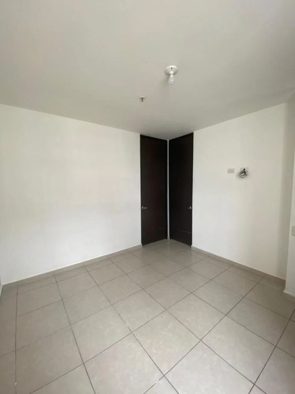 Bedroom with dark wood wardrobe and tile floor PH Alsacia Tower Condado del Rey Panama