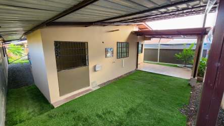 Back terrace covered with garden area and green views in corner villa La Chorrera Panama