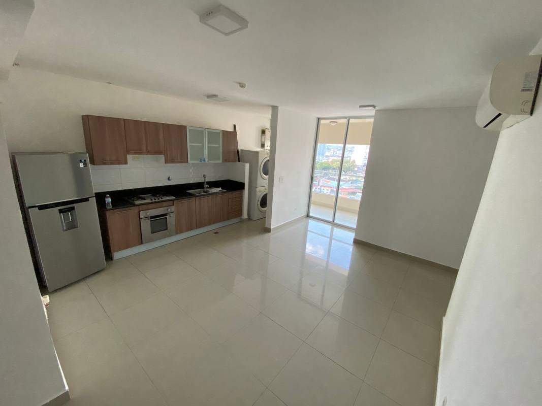 Modern kitchen with granite countertop, oven, gas stove, refrigerator and laundry area in PH San Francisco Gardens Panama