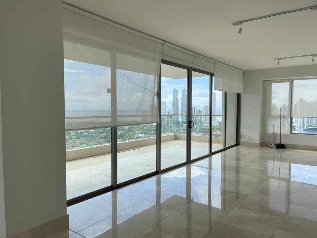 Open-plan living area with marble flooring, floor-to-ceiling windows and panoramic views at Santa María Panama