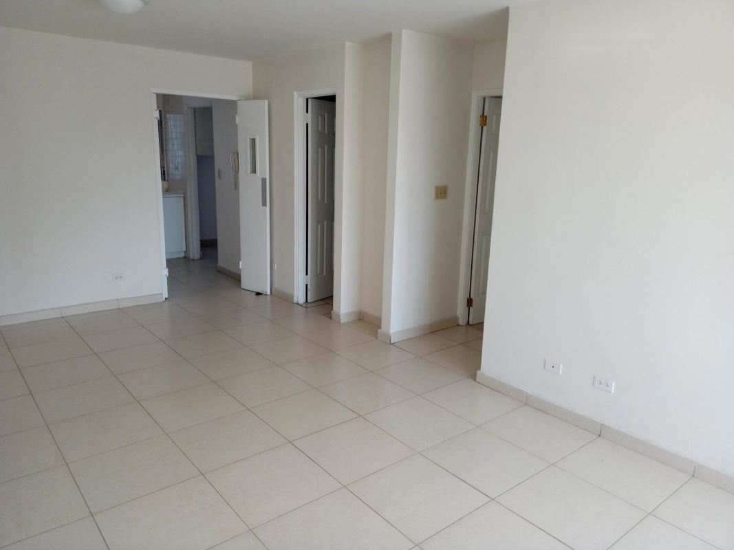 Living room with large windows showing cityscape in PH Park View I Panama