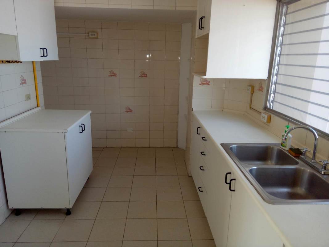 Traditional kitchen with double stainless steel sink, cabinets, window in PH Park View I El Dorado Panama