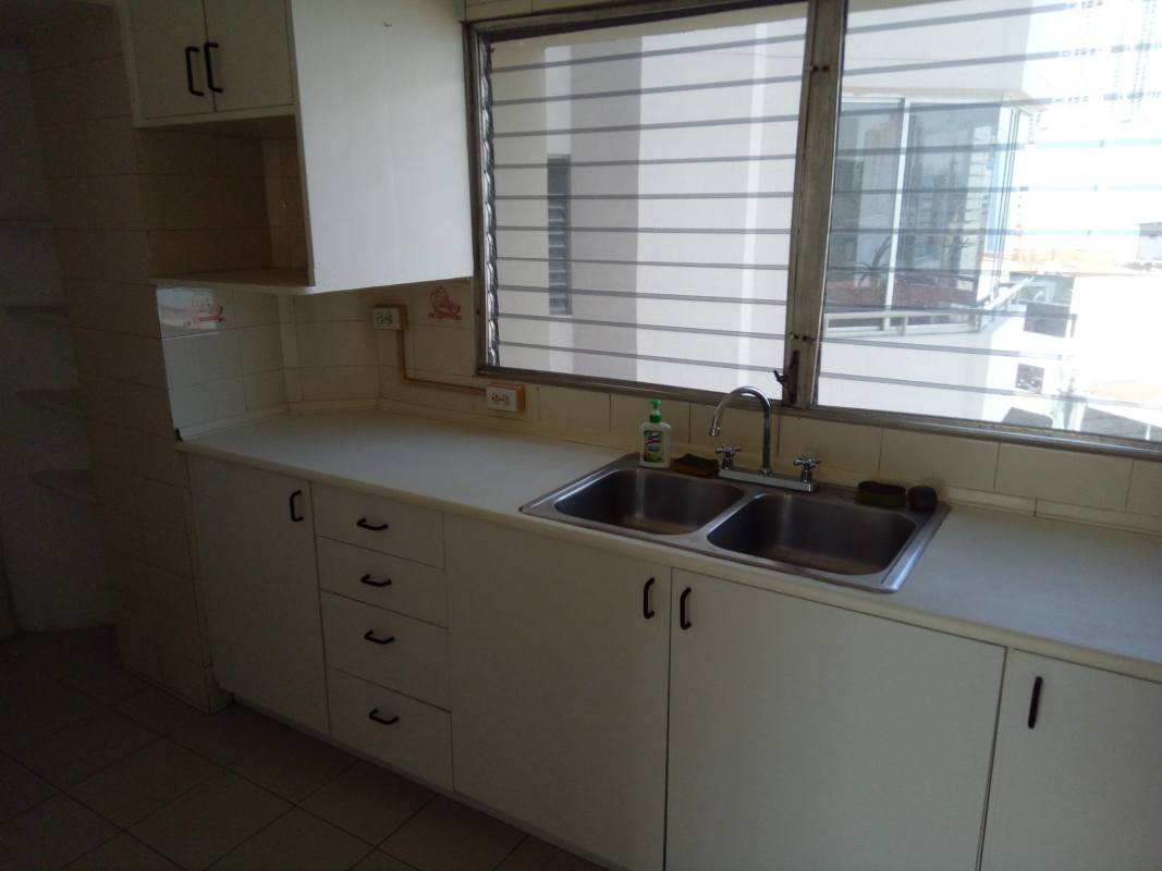 Simple minimalist kitchen with double sink, cabinets, window PH Park View I Panama City