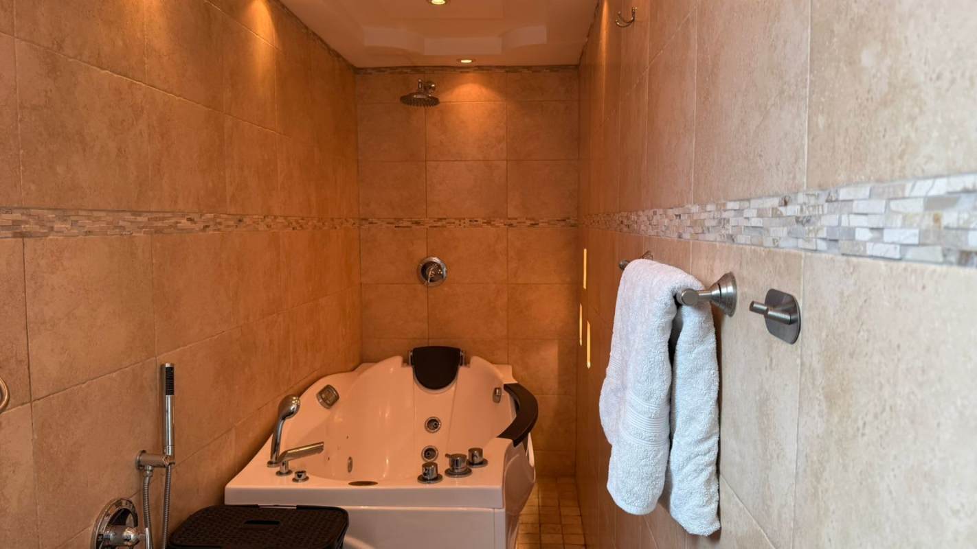 Modern bedroom with metallic wall, abstract art, built-in closet The Ocean Club Panama