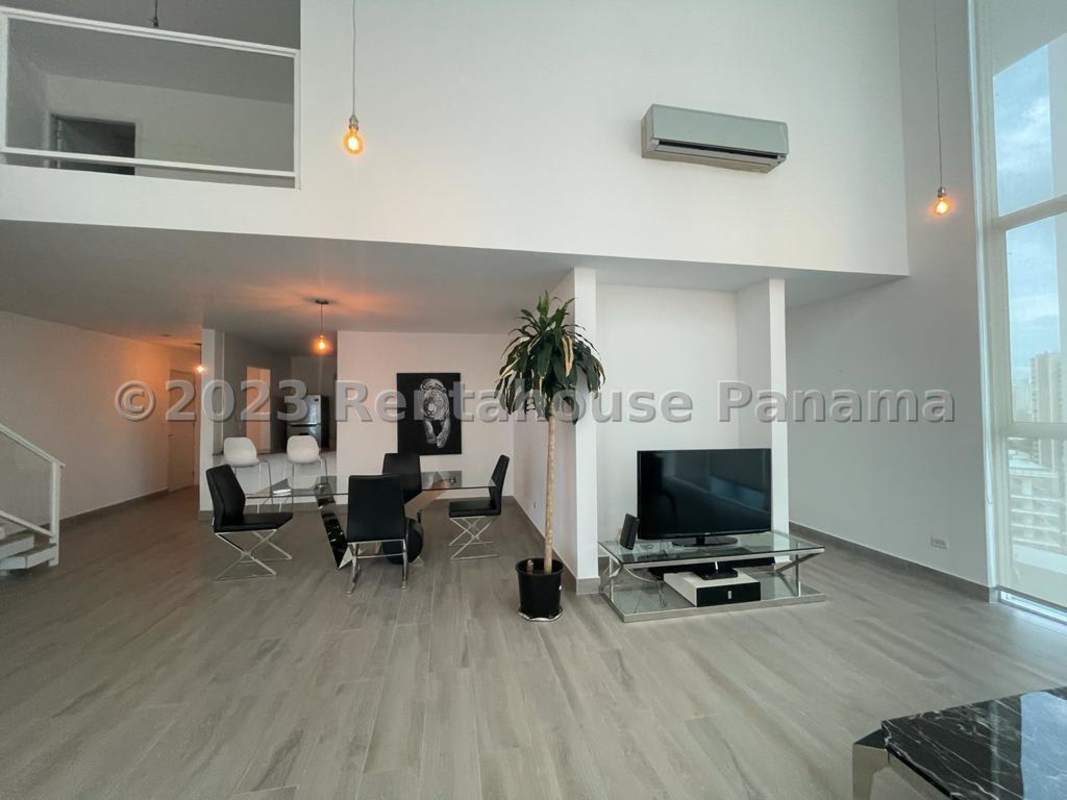 Modern loft living with floor-to-ceiling glass panels and bright open space in PH Mirador Bella Vista