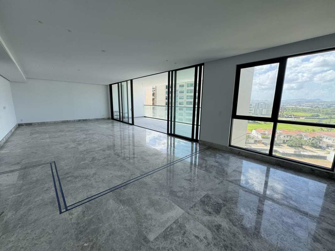 Modern open-plan living area with marble flooring, floor-to-ceiling windows overlooking Santa María golf at Empire Residences Panama
