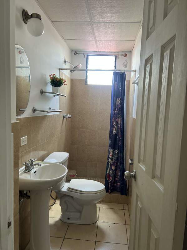 Compact bathroom design with shower and pedestal sink PH Saramel Parque Lefevre Panama