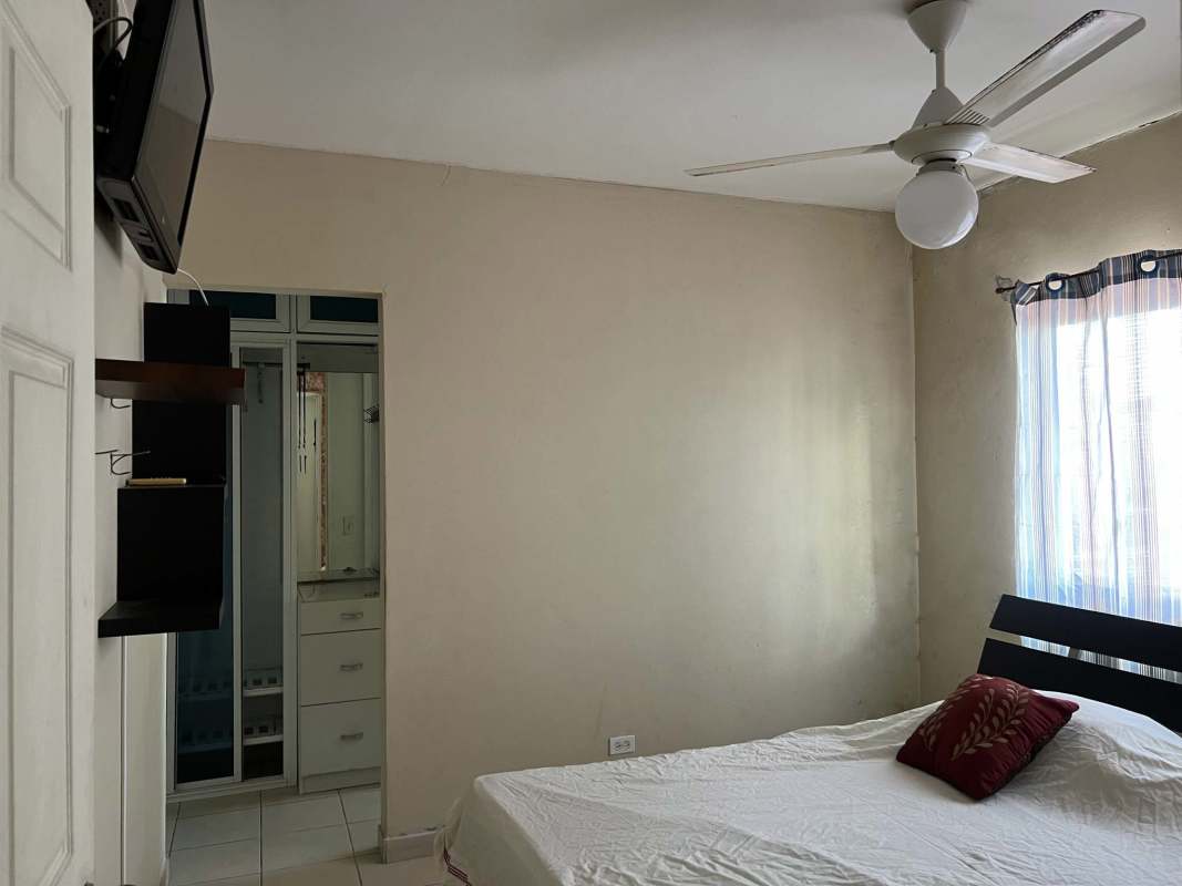 Bedroom with mirrored closet, ceiling fan, tiled floor in PH Saramel Parque Lefevre Panama