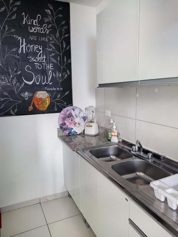 Kitchen with granite counter, double sink, cabinets and tile backsplash Panama