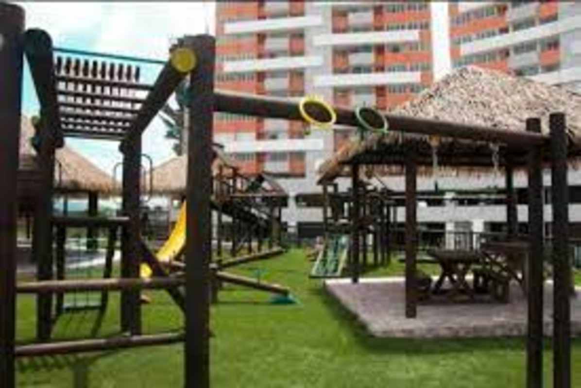Children's play area with climbing structures next to lush garden space at Villa Lucre Residences Panama