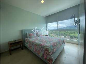 Bedroom with panoramic windows and ocean view in PH Royal Palm Chame Panama