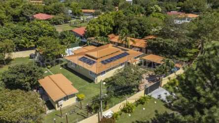 Aerial showing home, solar panels, garden, pool, and fenced yard in San Carlos Panama