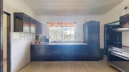 Covered outdoor terrace with ceiling fans, pool, lush landscaping, in Panama countryside home