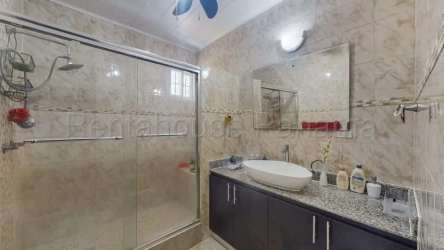 Modern bathroom with glass shower enclosure, vessel sink, granite top, Panama