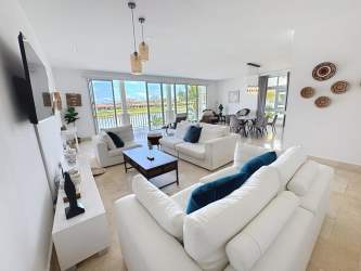 Spacious living and dining with natural light in lakefront villa at Ocean Lakes Buenaventura Panama