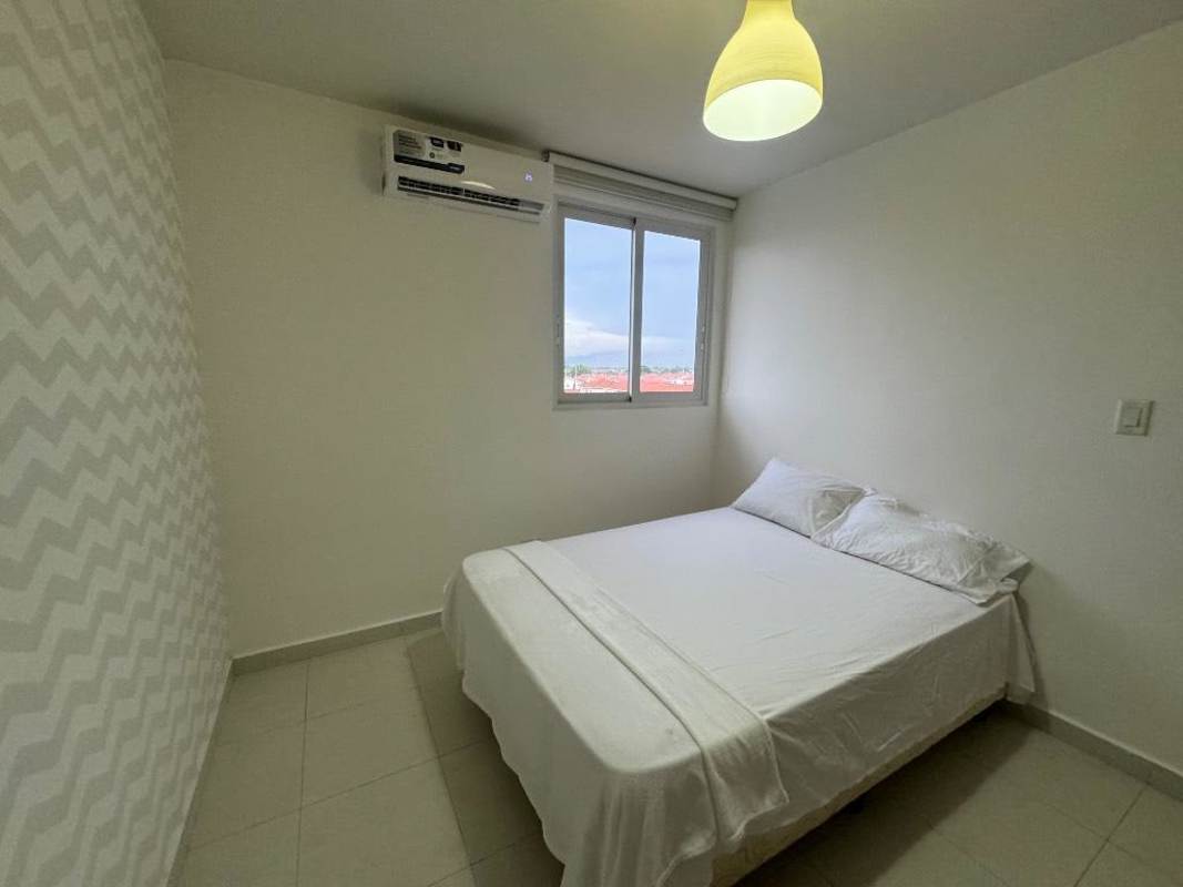 Furnished minimalist bedroom with AC, window and light at PH Torres de Versalles Costa Sur Panama