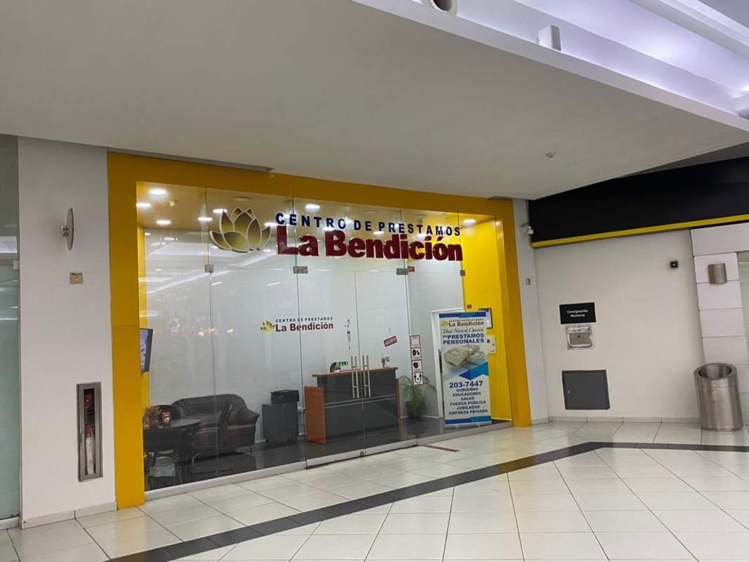 Glass-fronted retail or office space with company signage in Albrook Mall Panama City