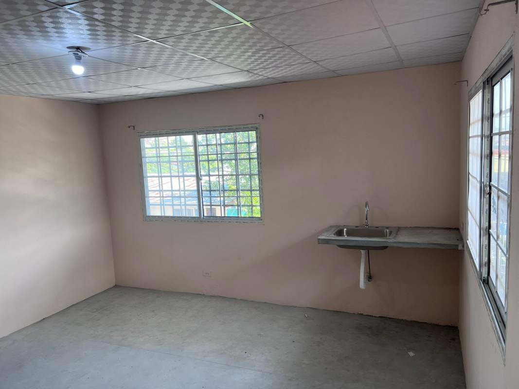 Minimalist kitchen with stainless sink large windows and metal bars rental in Panama City